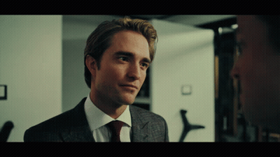 A Man In A Suit And Tie Looks To The Side GIF