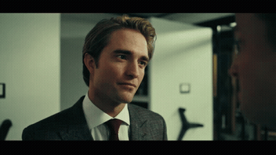 A Man In A Suit And Tie Looks To The Side GIF
