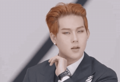 A Man In A Suit And Tie Makes A Heart Shape With His Hands GIF