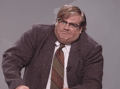 A Man In A Suit And Tie Making A Face GIF
