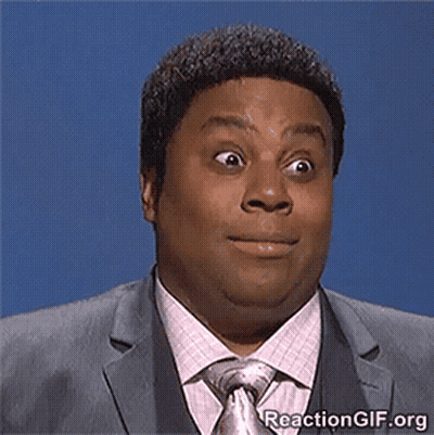 A Man In A Suit And Tie Making A Funny Face GIF