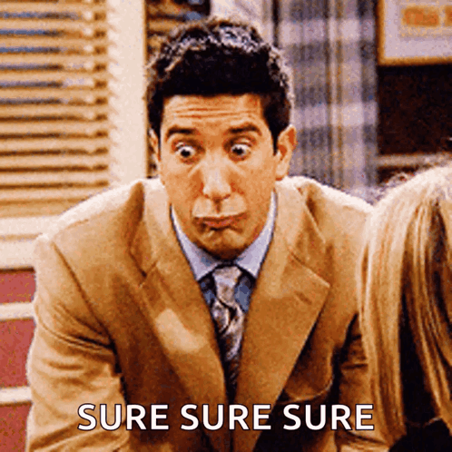 A Man In A Suit And Tie Making A Funny Face With The Words Sure Sure Sure Behind Him GIF