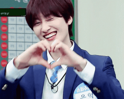 A Man In A Suit And Tie Making A Heart With His Hands GIF