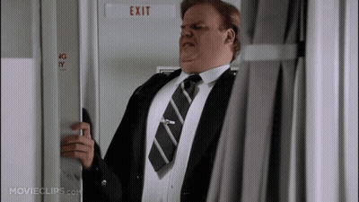 A Man In A Suit And Tie Opens An Exit Door GIF