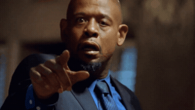 A Man In A Suit And Tie Points His Finger At The Camera GIF