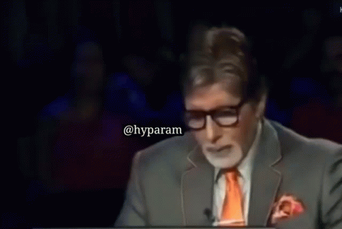 A Man In A Suit And Tie Says 7 Crore On A Screen GIF