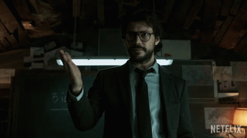 A Man In A Suit And Tie Says Bien In Front Of A Chalkboard GIF