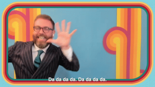 A Man In A Suit And Tie Says Da Da Da Da Da Da Da Da GIF