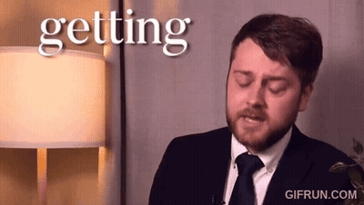 A Man In A Suit And Tie Says Getting GIF