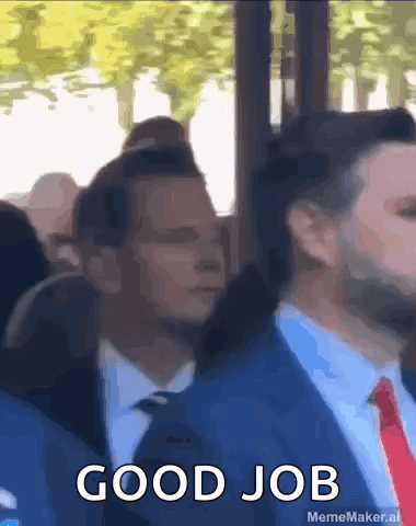 A Man In A Suit And Tie Says Good Job In Front Of A Crowd Of People GIF