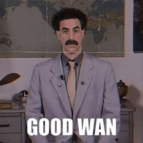 A Man In A Suit And Tie Says Good Wan In Front Of A World Map GIF
