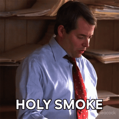 A Man In A Suit And Tie Says Holy Smoke GIF