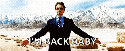 A Man In A Suit And Tie Says I 'M Back Baby With His Arms Outstretched GIF
