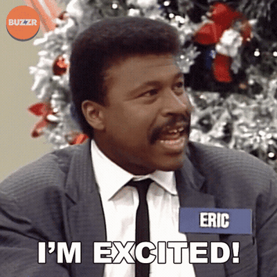 A Man In A Suit And Tie Says I 'M Excited In Front Of A Christmas Tree GIF