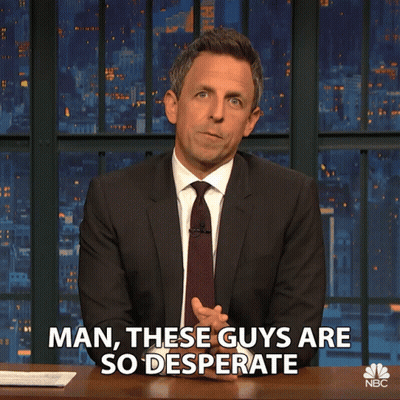 A Man In A Suit And Tie Says " Man These Guys Are So Desperate " While Sitting At A Desk GIF