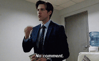 A Man In A Suit And Tie Says " No Comment " In Front Of A Water Cooler GIF
