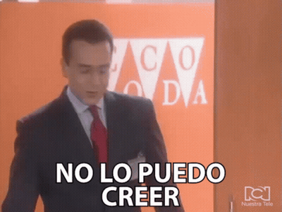 A Man In A Suit And Tie Says No Lo Puedo Creer In Front Of An Orange Wall GIF