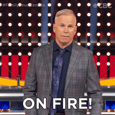 A Man In A Suit And Tie Says " On Fire " In Front Of A Crowd GIF
