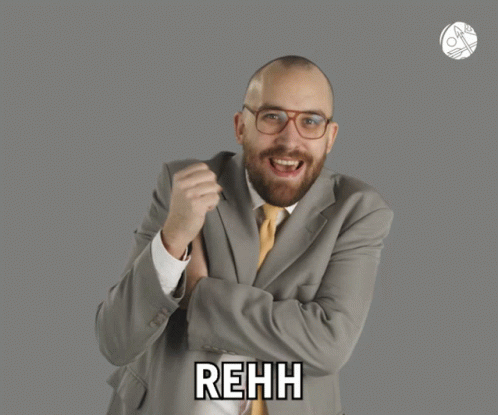 A Man In A Suit And Tie Says Rehh In Front Of A Gray Background GIF