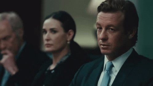 A Man In A Suit And Tie Says Sell It All In Front Of A Woman GIF