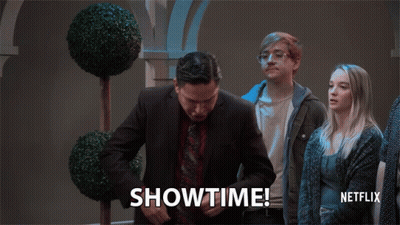 A Man In A Suit And Tie Says Showtime In Front Of A Netflix Logo GIF