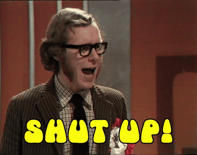 A Man In A Suit And Tie Says Shut Up In Yellow Letters GIF
