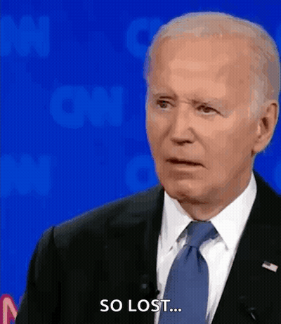 A Man In A Suit And Tie Says So Lost While Standing In Front Of A Blue Background . GIF