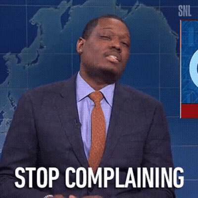 A Man In A Suit And Tie Says " Stop Complaining " In Front Of A Map Of The World GIF