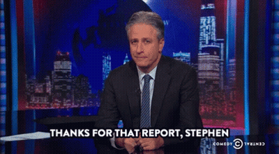 A Man In A Suit And Tie Says Thanks For That Report Stephen On A Comedy Central Show GIF