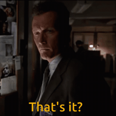 A Man In A Suit And Tie Says That 'S It In A Dark Room GIF