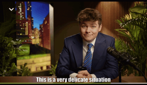 A Man In A Suit And Tie Says This Is A Very Delicate Situation In Front Of A Microphone GIF