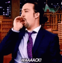 A Man In A Suit And Tie Says Waaaack GIF