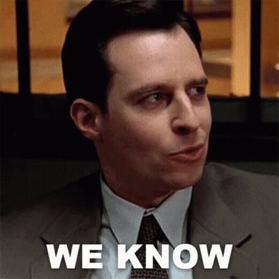 A Man In A Suit And Tie Says " We Know " In White Letters GIF