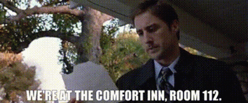 A Man In A Suit And Tie Says We 'Re At The Comfort Inn Room 112 .. GIF