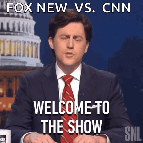 A Man In A Suit And Tie Says Welcome To The Show In Front Of The Cnn Building GIF