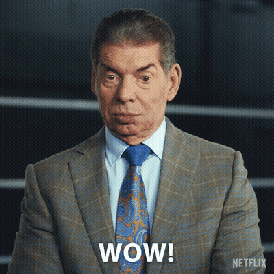 A Man In A Suit And Tie Says Wow On The Screen GIF