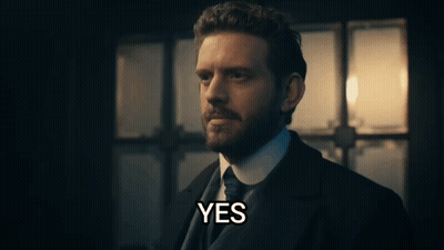 A Man In A Suit And Tie Says Yes In Front Of A Window GIF