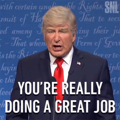 A Man In A Suit And Tie Says " You 'Re Really Doing A Great Job " At A Podium GIF
