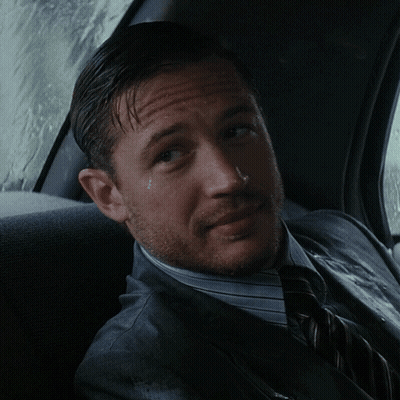 A Man In A Suit And Tie Sits In A Car GIF