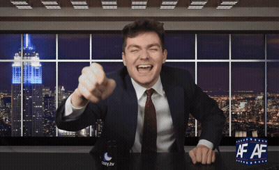 A Man In A Suit And Tie Sitting At A Desk With A Cup That Says Easy.tv On It GIF