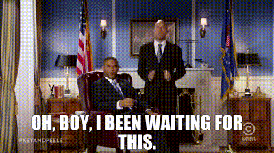 A Man In A Suit And Tie Sitting In A Chair With The Words Oh Boy I Been Waiting For This Above Him GIF