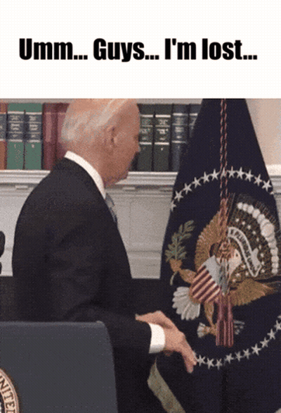 A Man In A Suit And Tie Sitting In Front Of A Flag With The Words Umm Guys I 'M Lost GIF