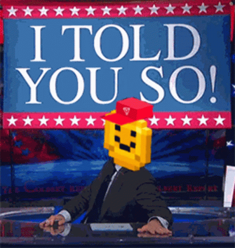 A Man In A Suit And Tie Sitting In Front Of A Sign That Says I Told You So GIF