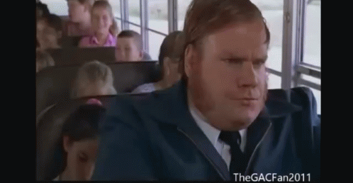 A Man In A Suit And Tie Sitting On A Bus GIF