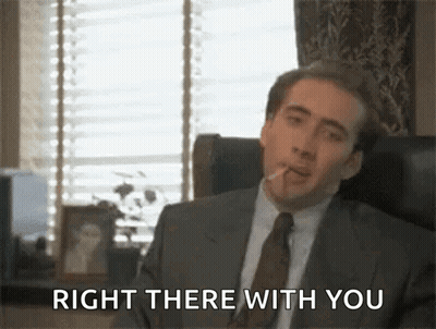 A Man In A Suit And Tie Smoking A Cigarette And Saying Right There With You . GIF