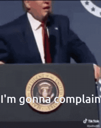 A Man In A Suit And Tie Stands At A Podium And Says I 'M Gonna Complain .. GIF