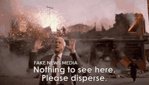 A Man In A Suit And Tie Stands In Front Of A Building That Is On Fire And Says Fake News Media Nothing To See Here GIF