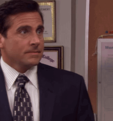A Man In A Suit And Tie Stands In Front Of A Bulletin Board That Says " Monday " GIF