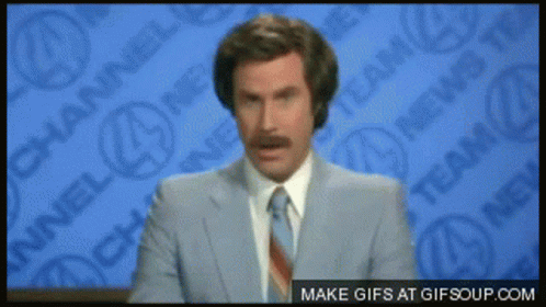 A Man In A Suit And Tie Stands In Front Of A Channel 4 News Wall GIF