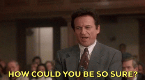 A Man In A Suit And Tie Stands In Front Of A Crowd And Says How Could You Be So Sure GIF